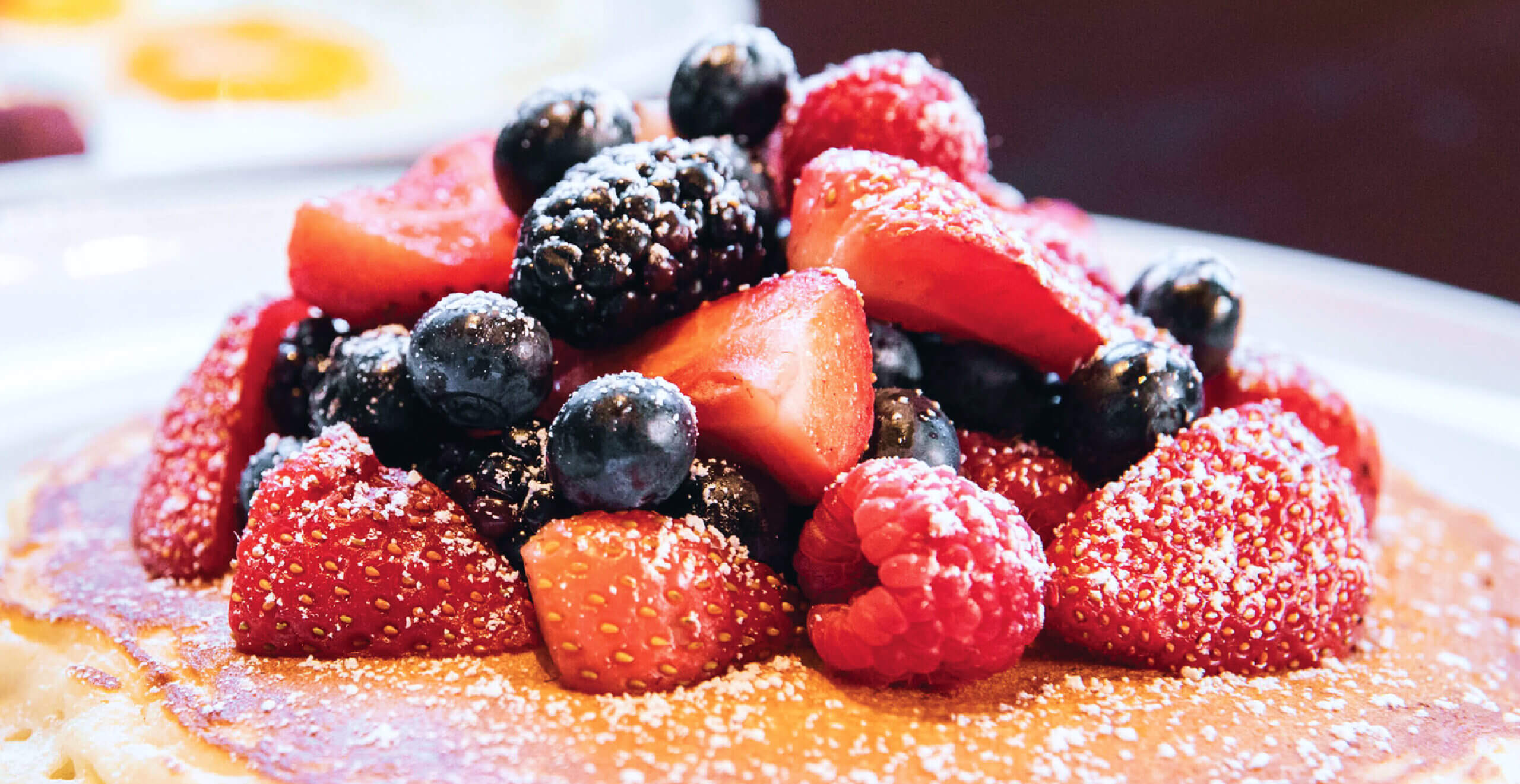 Buttermilk pancakes topped with fresh berries at Ellen’s