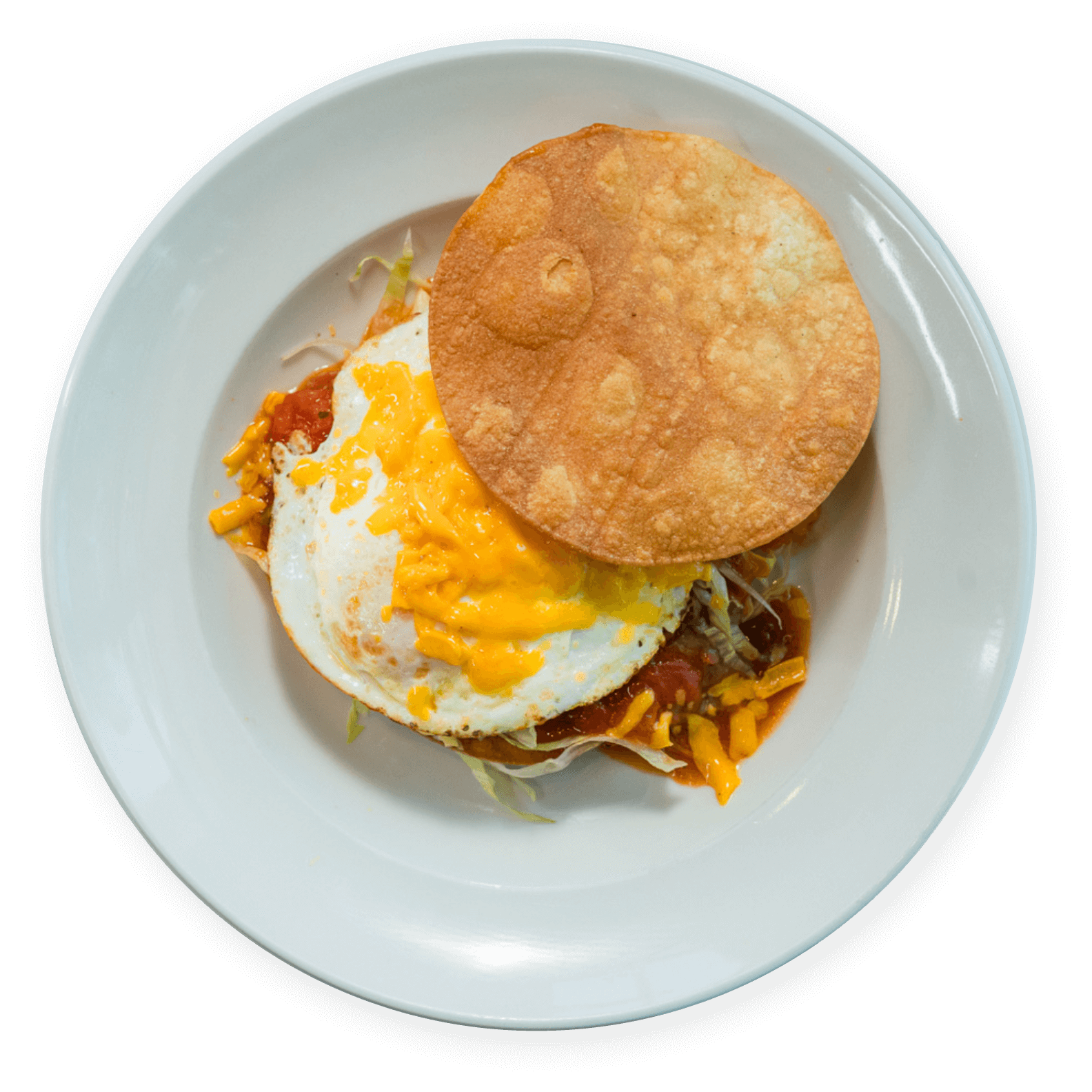 Eggs Benedict over grits with sautéed greens at Ellen’s Southern Kitchen in Dallas