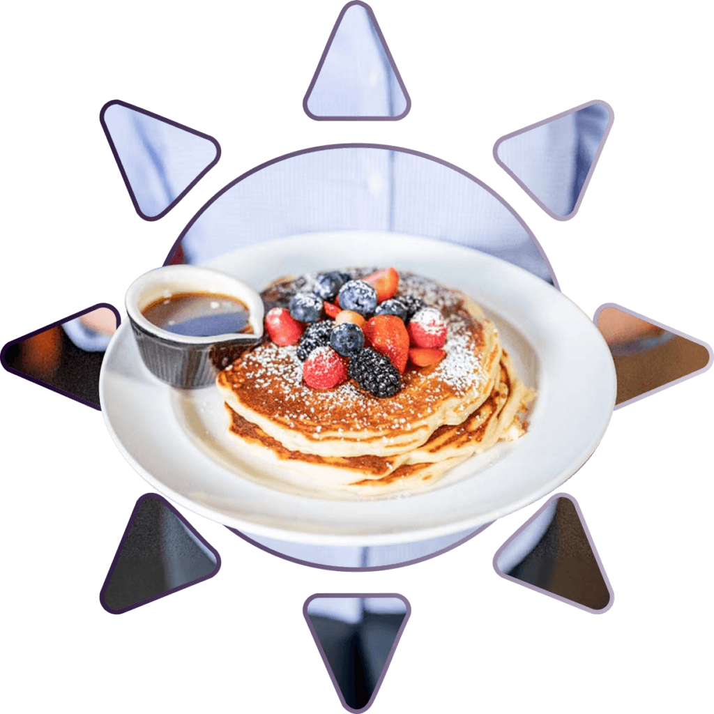 Buttermilk pancakes topped with fresh berries at Ellen’s