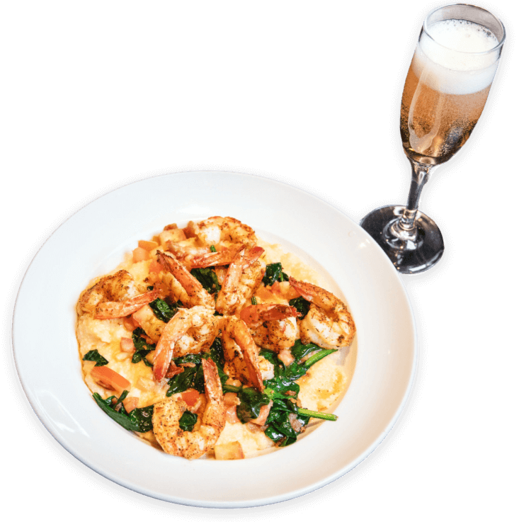 Shrimp and grits served with champagne at Ellen’s Southern Kitchen